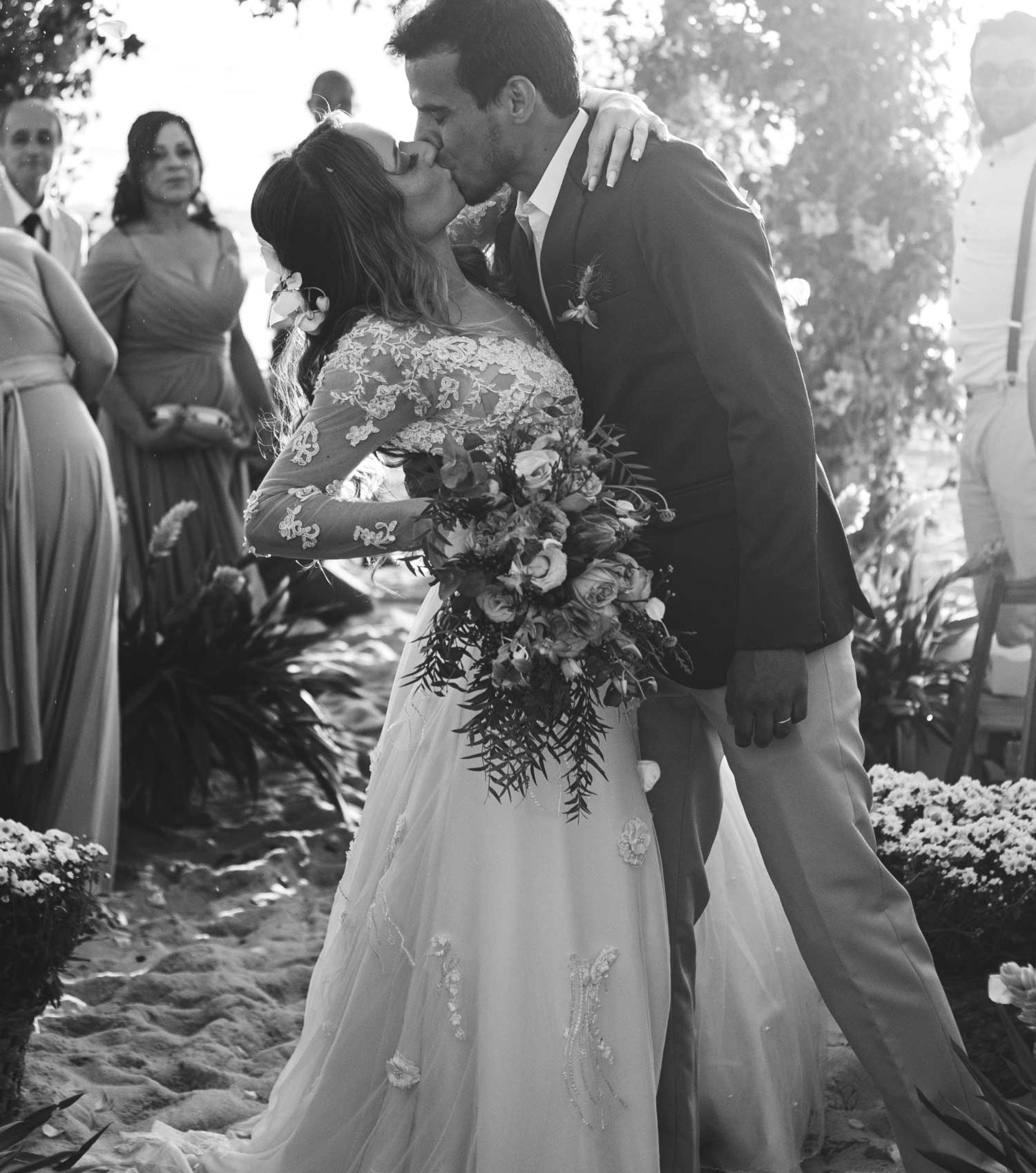 Сouple wearing a white gown and a black suit. Mobile image