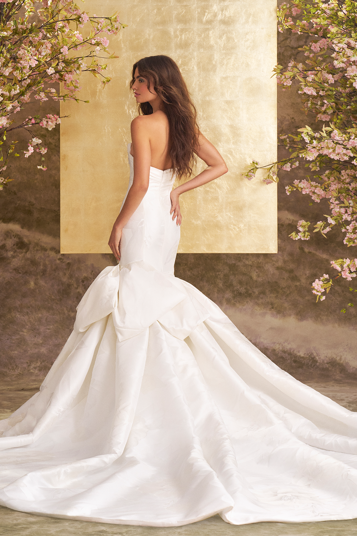 model is wearing a strapless mermaid bridal gown