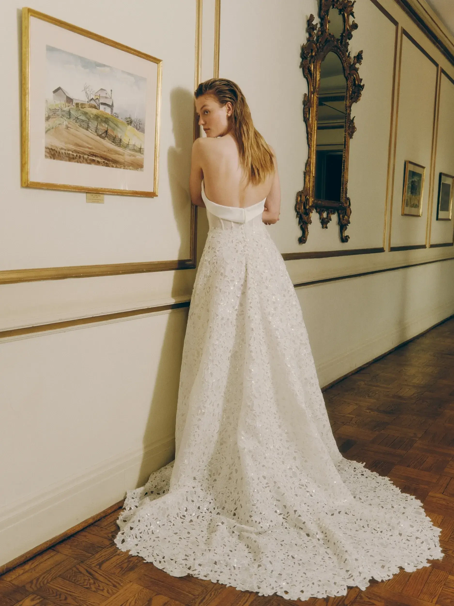 model is wearing a low back a-line wedding dress