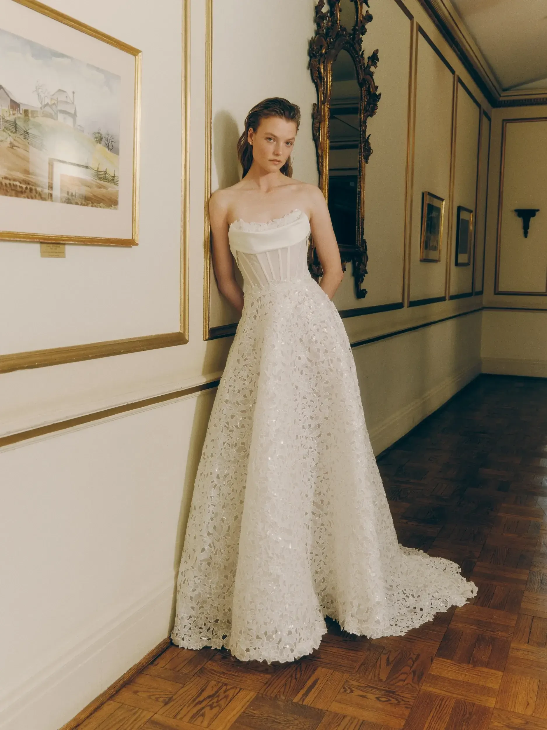 model is wearing a low back a-line wedding dress