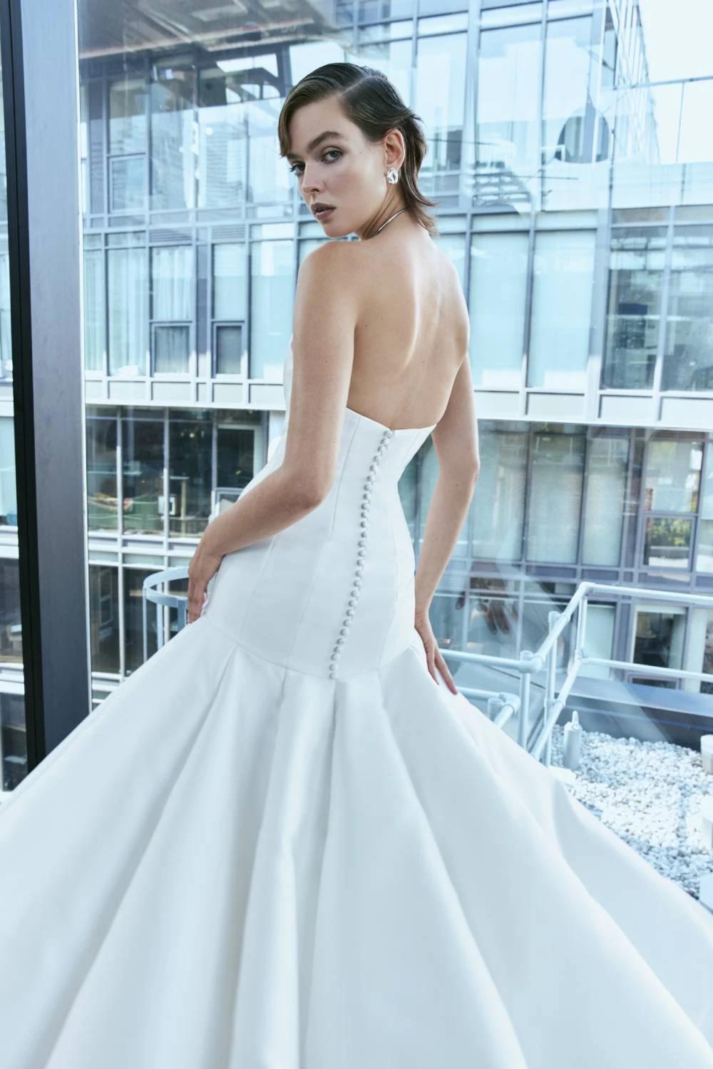 Model wearing a white dress by Rita Vinieris