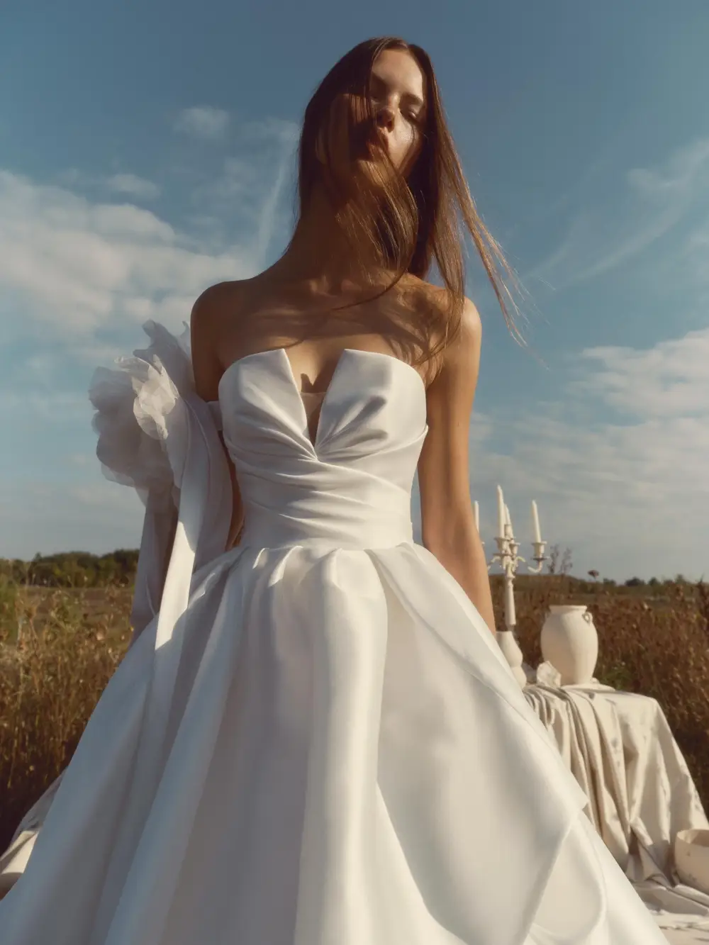 model is wearing a strapless ball gown