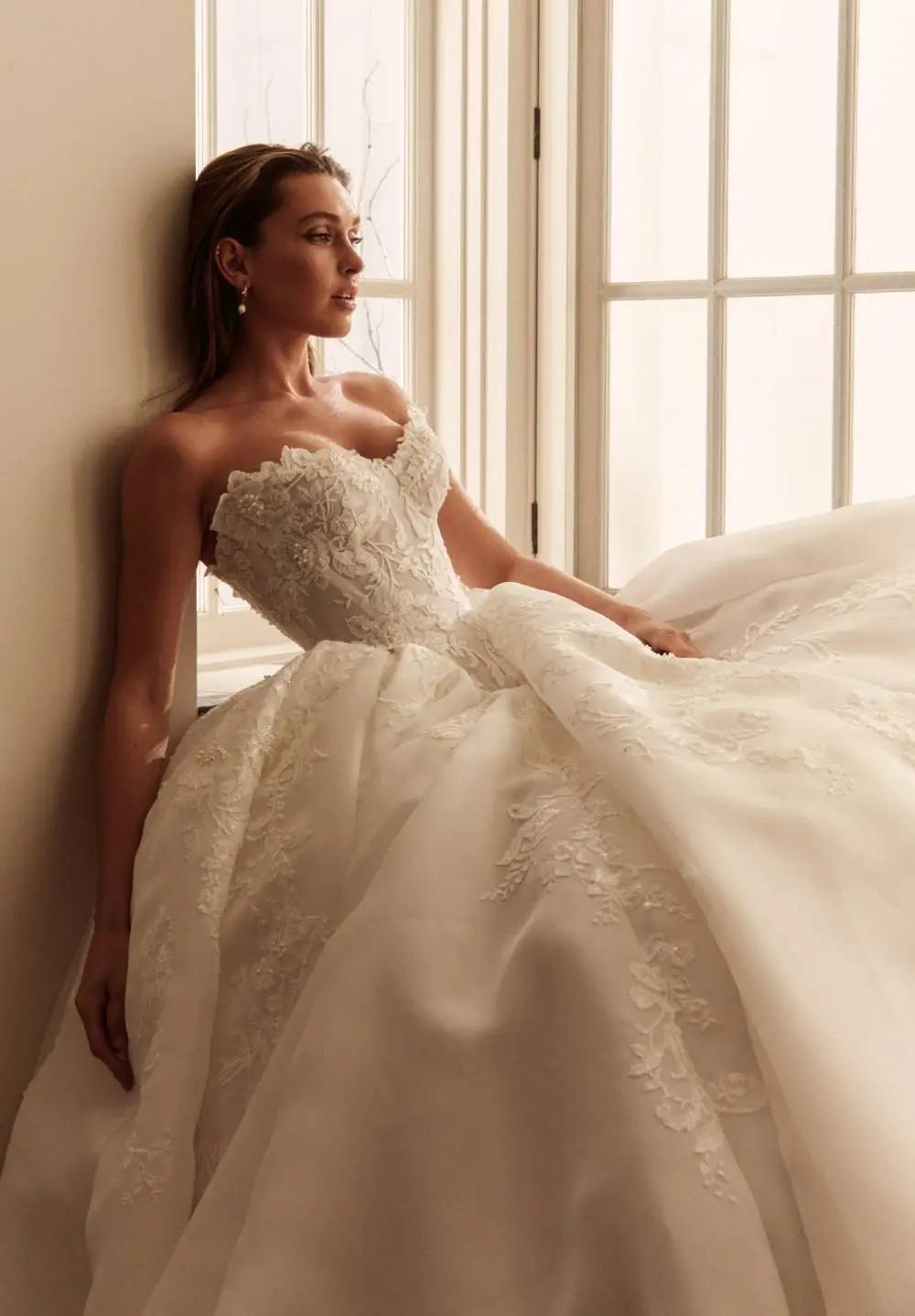 Model wearing a white dress by Leah Da Gloria