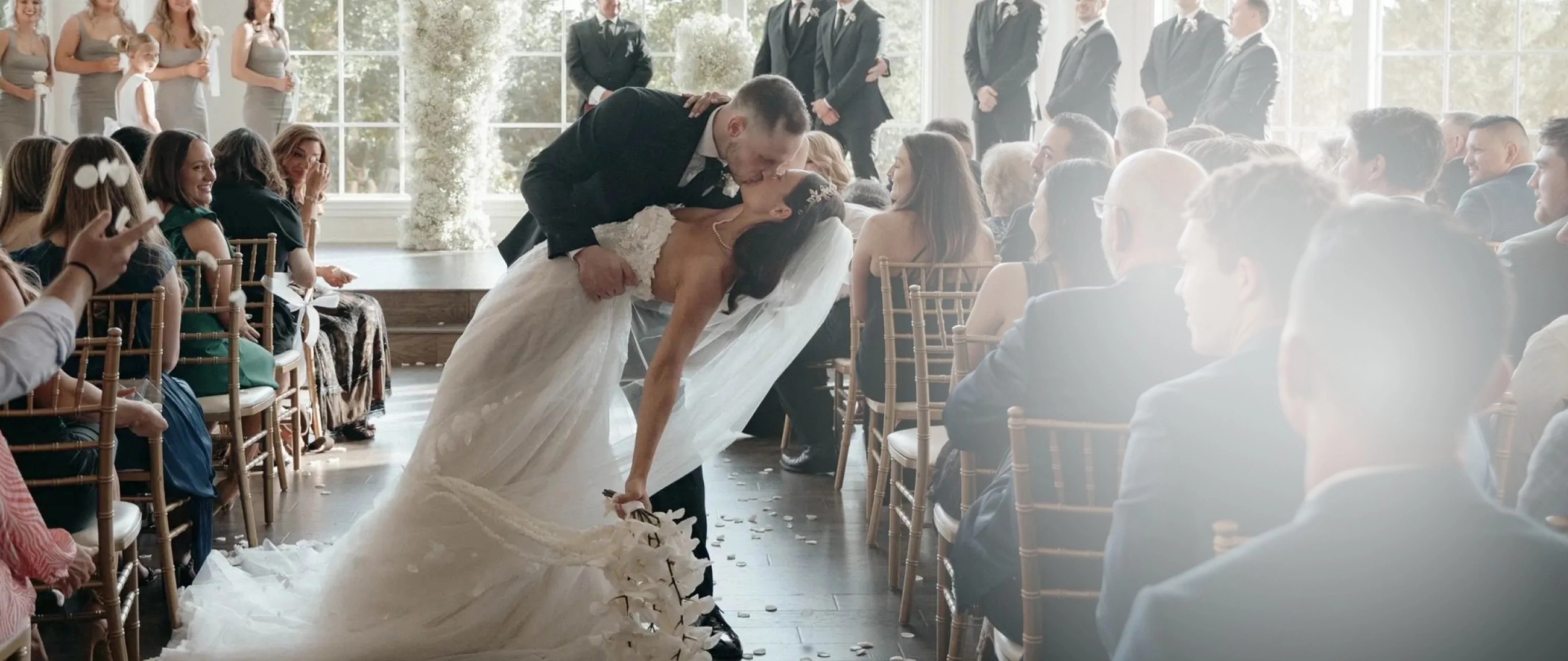 Сouple wearing a white gown and a black suit