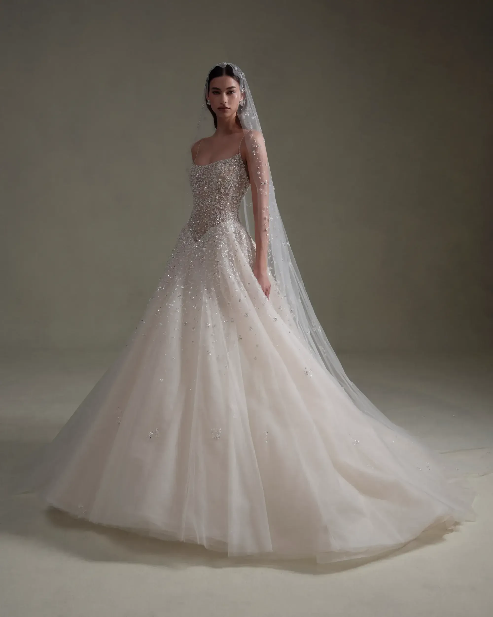 model is wearing a tulle ball gown wedding dress