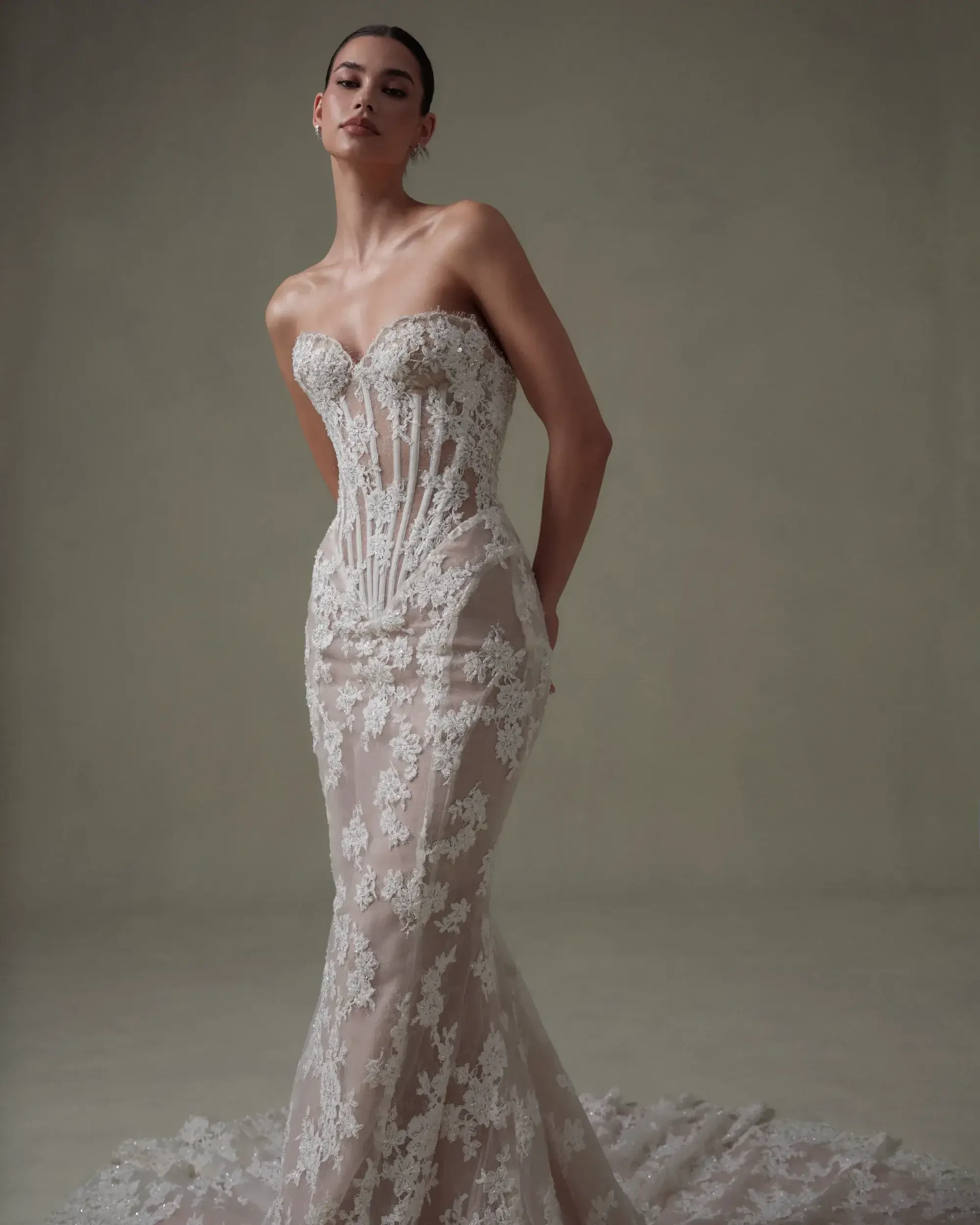 model is wearing a strapless lace mermaid wedding dress