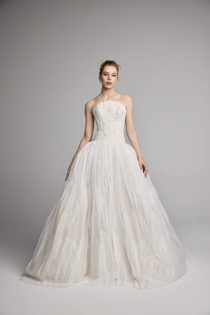 Model wearing a white dress by Pnina Tornai