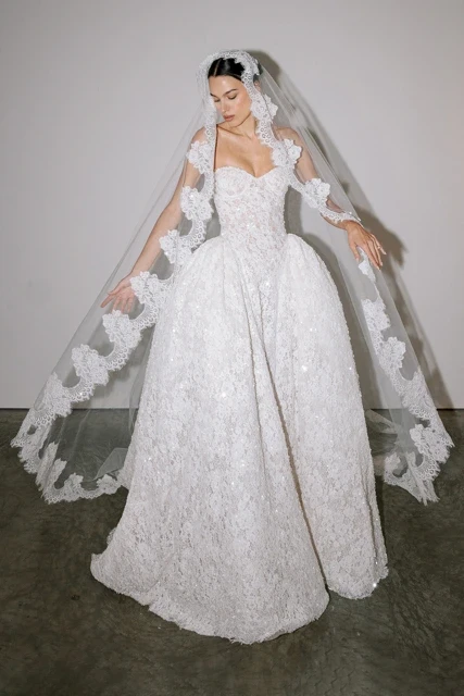 Model wearing a white dress by Pnina Tornai