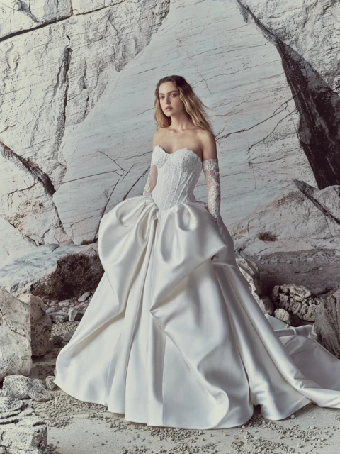Model wearing a white dress by Rita Vinieris